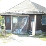 again and again - the destructed hut provisorily repaired with plastic foils